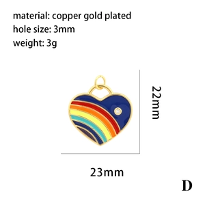 Detail view of 18K gold plated heart pendant with blue enamel and rainbow stripes
