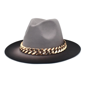 Detail of grey and black felt fedora featuring a chunky gold metal chain link band