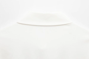 Close-up of white collared romper dress showing back neckline and twill fabric texture