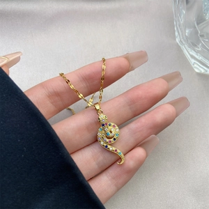 Detailed view of snake pendant necklace featuring colorful cubic zirconia and 18K gold plating