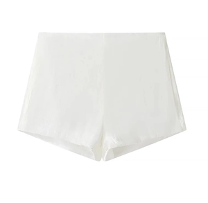 Close-up of white satin shorts with elastic waist and delicate shimmering fabric texture