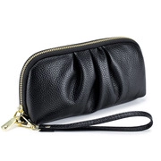 Detailed view of black genuine leather clutch bag with pleated texture and gold hardware