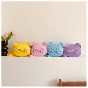 Row of colorful mini cat-shaped shoulder bags with decorative bows for children