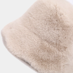 Close-up of premium beige faux fur texture on a warm winter bucket hat with ruffle edge