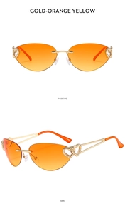 Detail view of rimless Y2K sunglasses with gold frame, heart cutout, and orange gradient lenses