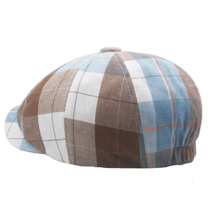 Macro shot of the brown and blue plaid fabric texture and woven patterns on the beret hat
