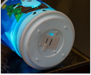 Detail view of the bottom power switch and CE certification on a blue Christmas LED candle