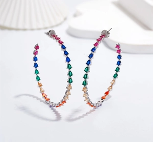 Detailed close-up of large hoop earrings with rainbow teardrop-shaped zircon stones