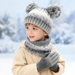 Close-up of kids winter knit set featuring tie-dye gradient beanie with two pom-poms