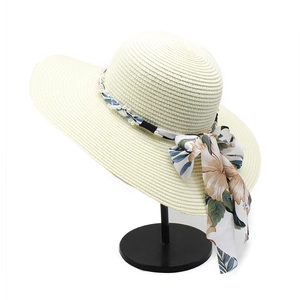 Wide brim cream straw hat with floral scarf and pearl chain decoration