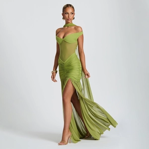 Detail of green strapless dress featuring sheer mesh panels, ruched texture and high slit