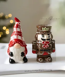 Detailed view of ceramic Christmas gnome and nutcracker figurines on decorative books