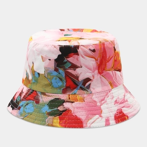 Detailed view of reversible bucket hat featuring colorful floral patterns and neat stitching