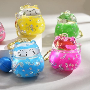 Lucky Maneki Neko keychains with colorful glitter floating oil in acrylic casing