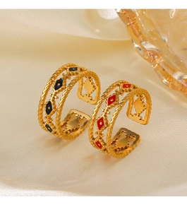 Detailed macro of vintage bohemian evil eye rings in black and red enamel finish