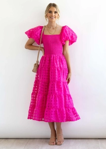 Detail of puffed sleeves and elastic waist on a rose pink checkered organza midi dress
