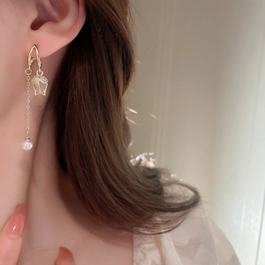 Elegant gold tulip earrings with cubic zirconia and hanging pearl tassels on model