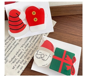 Detail view of colorful resin Christmas hair clips set including Santa and hat designs