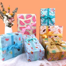 Assorted summer gift wrapping paper featuring colorful fruit patterns and decorative ribbons