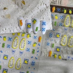 Macro shot of 3D embossed lemon and fruit nail stickers with adhesive backing