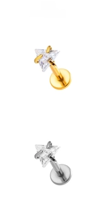 Macro detail of triangle cut cubic zirconia studs with polished gold and silver prong settings