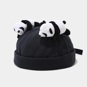 Detail of a black cotton docker hat featuring two cute 3D panda plush toys on top