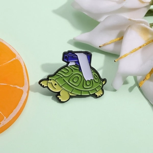 Macro shot of green turtle warrior enamel pin with deep green shell on fruit background