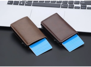 Detail view of RFID blocking pop-up wallets in vintage brown leather on an office desk