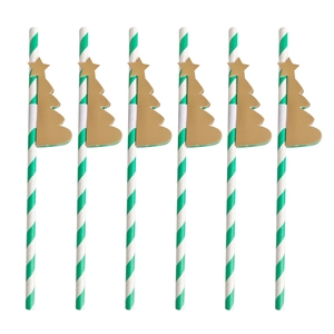 Detail of six green striped paper straws with golden Christmas tree honeycomb toppers