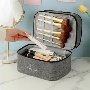 Grey large-capacity double-layer travel makeup bag with waterproof fabric and brush slots