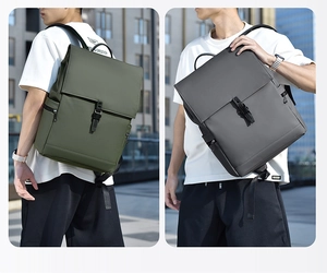 Close-up of military green and dark grey waterproof backpacks with matte texture and flap design