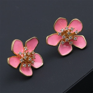 Detailed view of pink enamel flower earrings with sparkling cubic zirconia centers