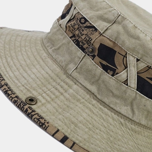 Vintage wash canvas bucket hat with newspaper print tape and bronze metal button decor