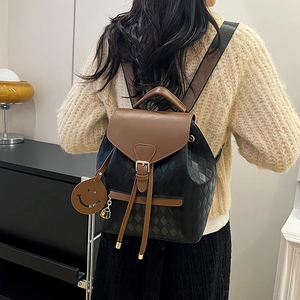 Fashionable quilted black and brown leather backpack for women shown on a model