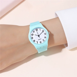 Wrist-worn view of mint green silicone quartz watch with clear numeric dial