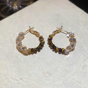 Detailed view of 18k gold plated hoop earrings with tiger eye beads and zircon stones