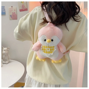 Rear view of a model wearing the cute pink and white penguin plush backpack with plaid bib