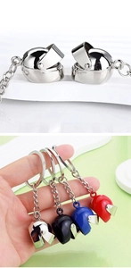 Macro detail of 3D motorcycle helmet keychains showing movable visor in four colors