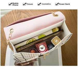 Detail view of the interior space showing tweed shoulder bag capacity and gold hardware