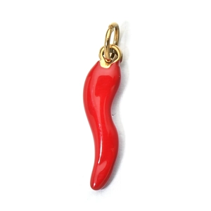 Detailed view of a shiny red chili pepper pendant with a golden metal loop on white background