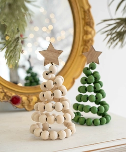 Detail of wooden beaded Christmas trees with star toppers in a festive indoor setting
