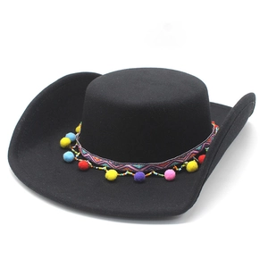 Close-up of ethnic braided band with colorful pom-poms on a black felt western cowboy hat