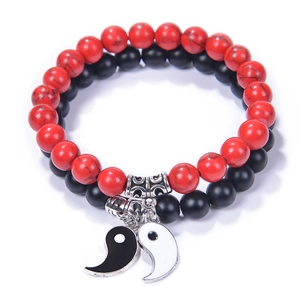 Detail of Yin Yang Tai Chi bracelets with matte black and red stone beads for couples