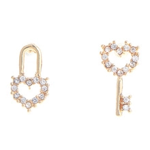 Detail of gold-plated heart lock and key earrings with sparkling clear crystals