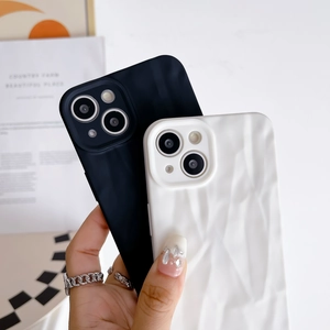 Close-up of black and white wrinkled silicone cases for iPhone 15 Pro Max models