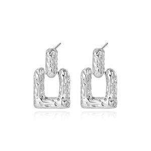 Silver square geometric earrings with textured hammer pattern on white background