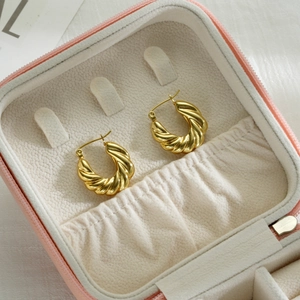 Polished 18k gold plated twisted hoop earrings displayed in a pink jewelry box