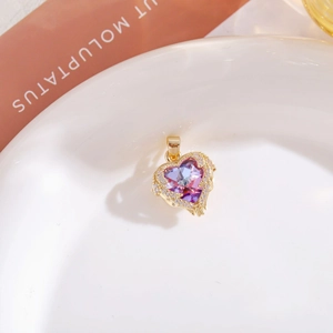 Detailed view of a purple heart-shaped crystal pendant with white zircon pavé setting