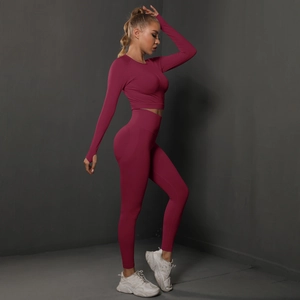 Close-up of burgundy seamless yoga set featuring thumb hole cuffs and high waist leggings