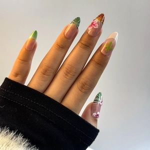 Detailed shot of almond-shaped press-on nails with 3D floral accents and leopard print